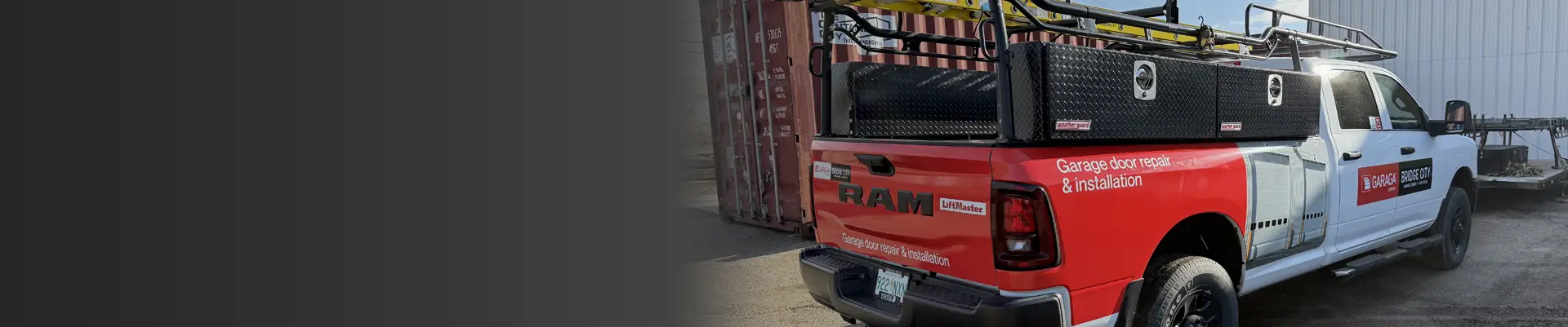 A pickup truck equipped with a ladder on the roof, ready for job use.